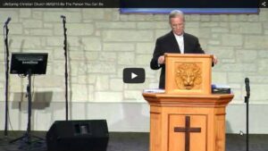 Pastor delivering sermon at church podium.