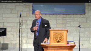 Speaker delivering sermon at church podium stage