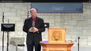 Man speaking at church podium during service