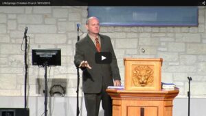 Man speaking at church podium during sermon