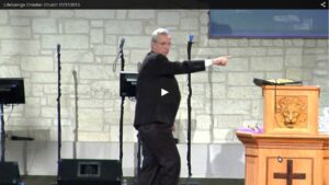 Man speaking at church podium during service