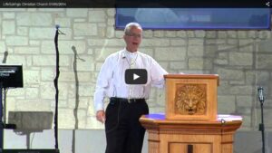 Church speaker delivering sermon at podium indoors