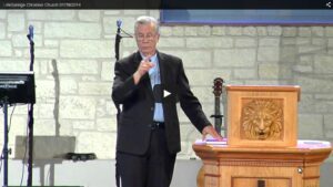 Speaker delivering a sermon at a church.