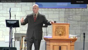 Man delivering sermon at a church podium