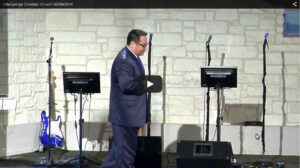 Man speaking at church with music equipment