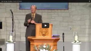 Pastor delivering sermon at church service podium