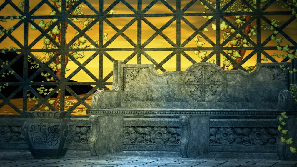 Stone bench in garden with sunset backdrop