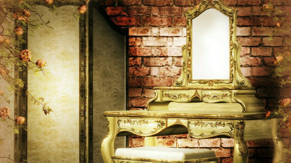 Vintage vanity table with ornate mirror design.