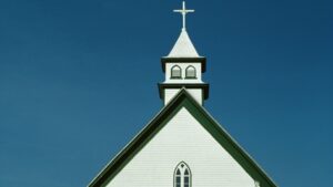 White church steeple against clear blue sky