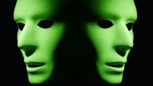 Green theatrical masks with dramatic lighting effect.