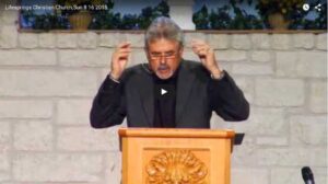 Man delivering sermon at church podium indoors