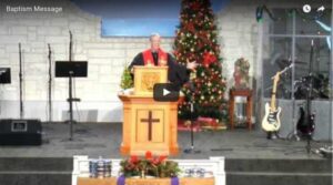 Pastor delivering sermon at decorated church altar