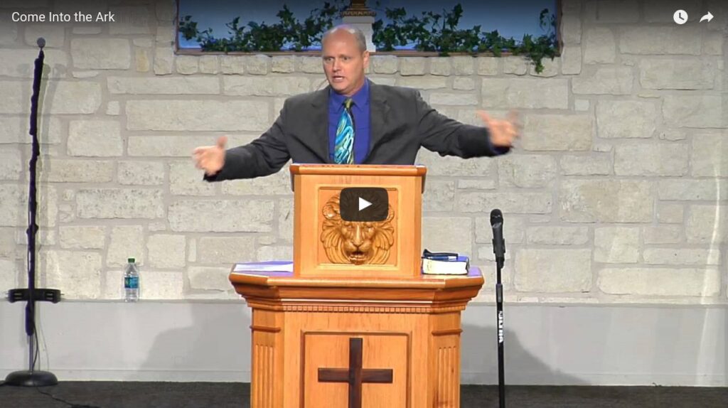 Man speaking at church podium during sermon