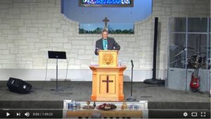 Pastor delivering sermon at church podium stage