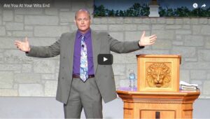 Man speaking passionately at church podium lectern