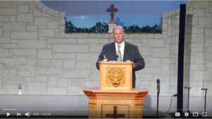 Speaker delivering a sermon at a church podium