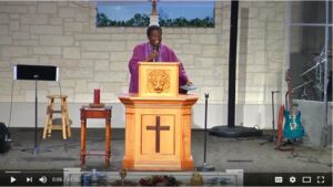 Pastor delivering sermon at church podium.