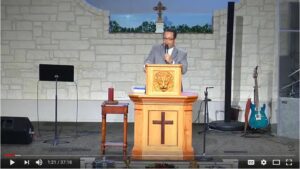 Pastor delivering sermon at church pulpit podium