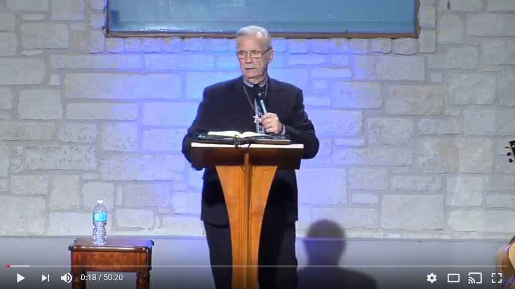 Man delivering a sermon at a podium.