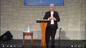 Man speaking at a church podium presentation