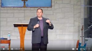 Man giving a speech at a podium