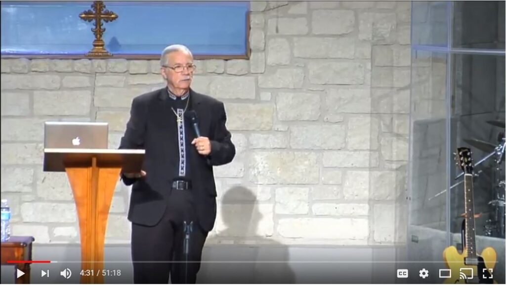 Speaker presenting at church with a microphone