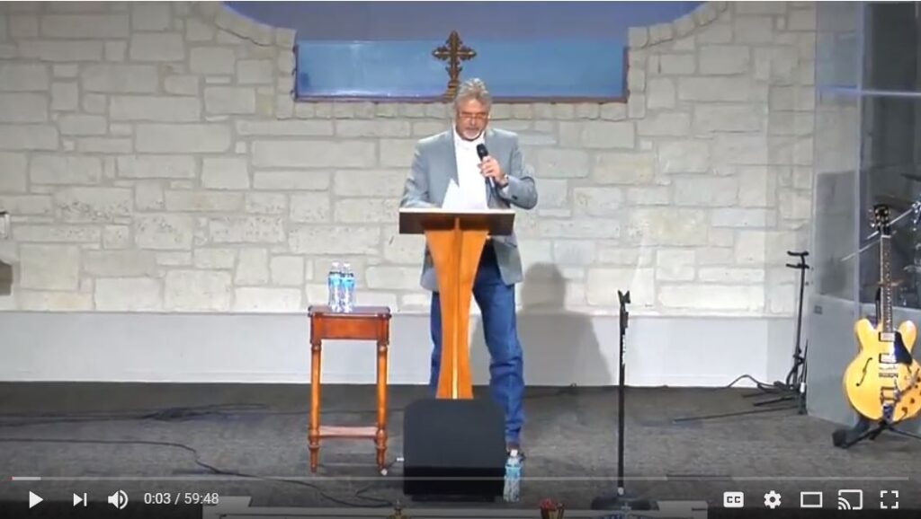 Person speaking at a church podium event.