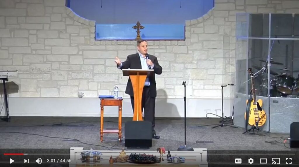 Speaker delivering a sermon at a church podium