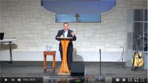 Speaker delivering sermon in church sanctuary pulpit