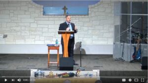 Person speaking at church podium during service