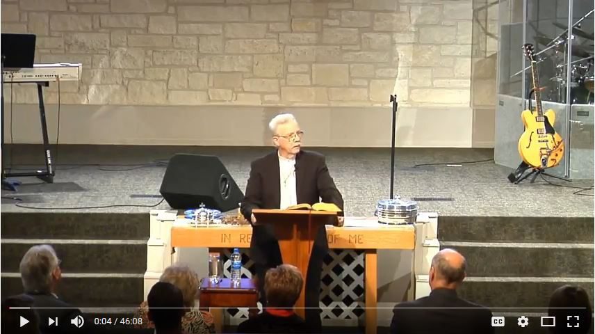 Man delivering sermon at church podium stage