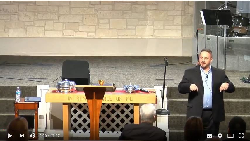 Pastor delivering sermon at church altar