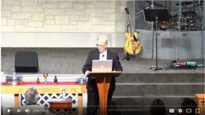 Speaker presenting at a church service podium