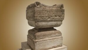 Ancient stone base sculpture with inscriptions exhibited