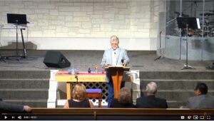 Speaker giving a sermon in a church.