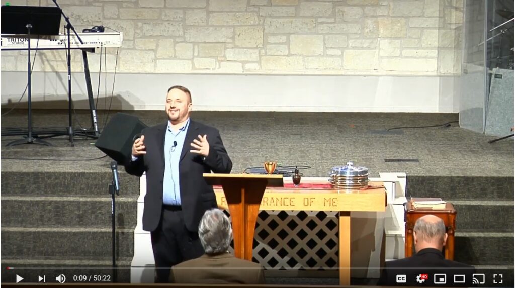 Man giving a sermon on church stage