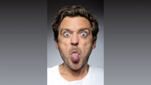 Man making funny face with tongue out