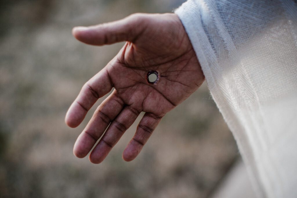 Hand with small round object in palm