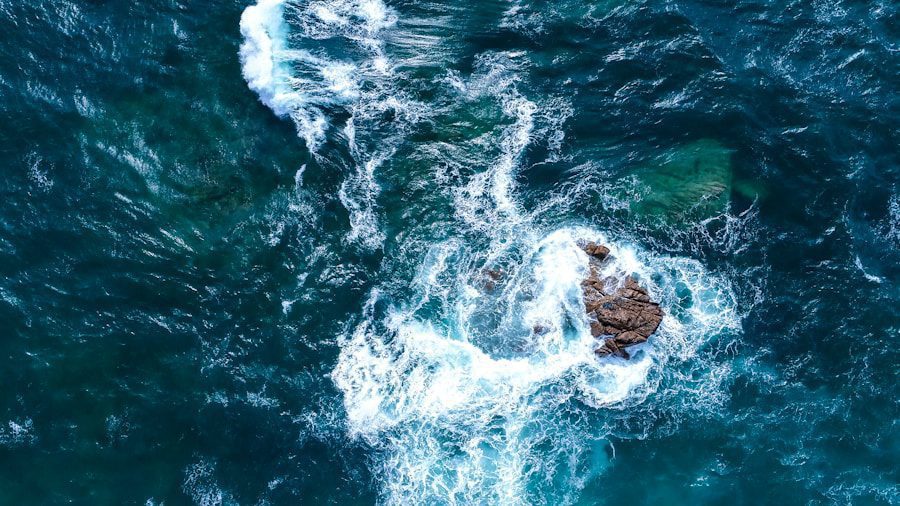 Aerial view of ocean waves crashing rocks