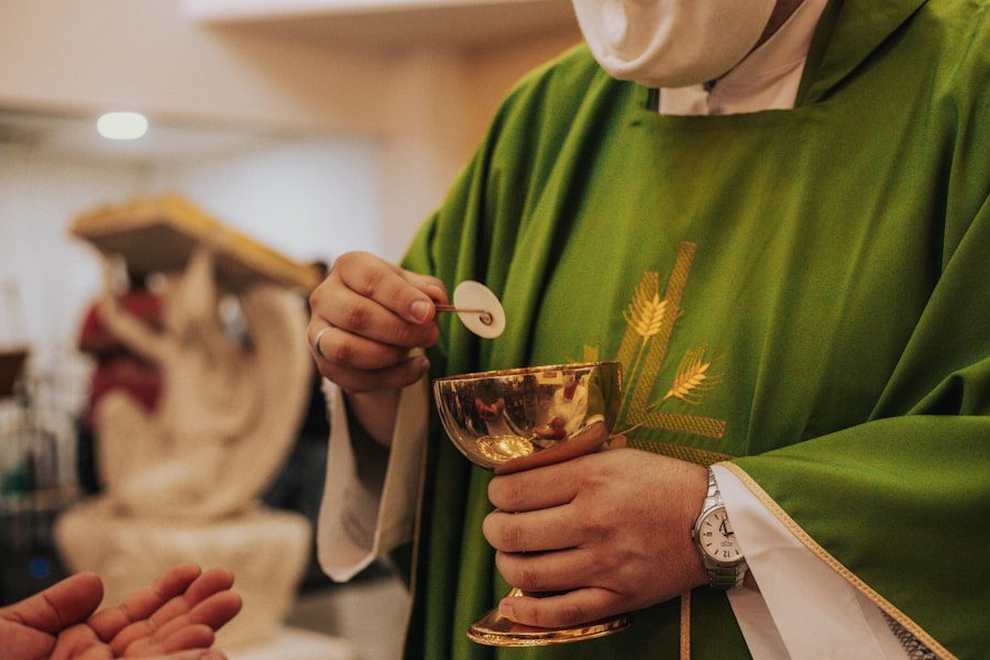 Priest holding chalice during religious communion ceremony