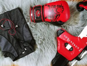 Boxing gear and gym clothing on rug