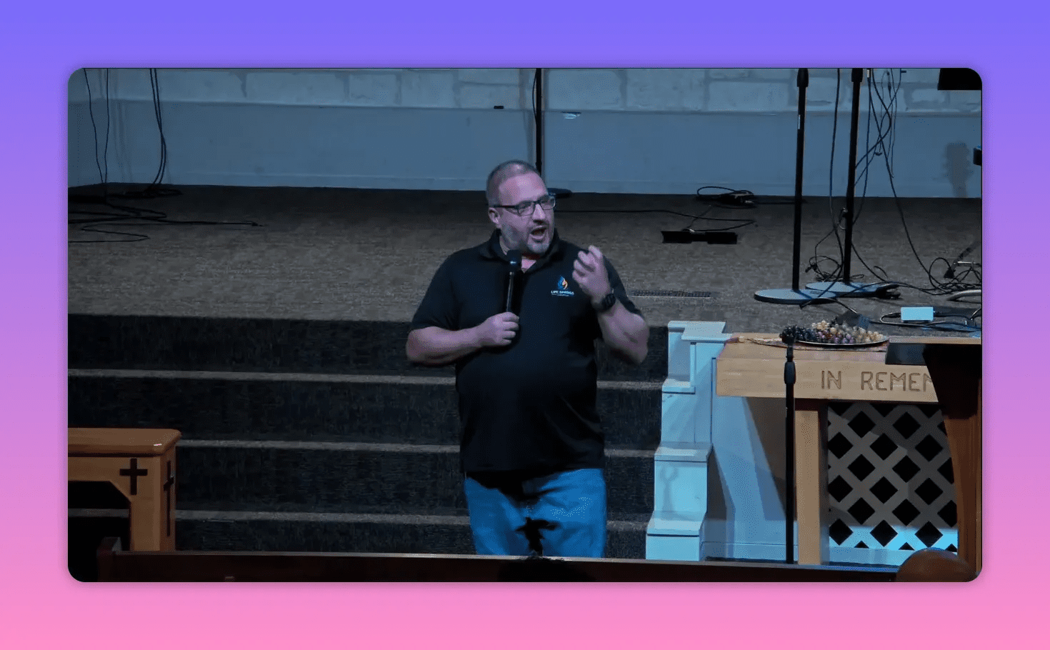 Speaker on church stage gesturing while explaining responsibility and liberty