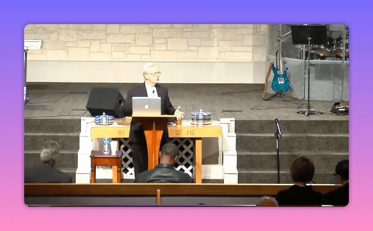 centered pulpit with laptop and communion trays on church platform