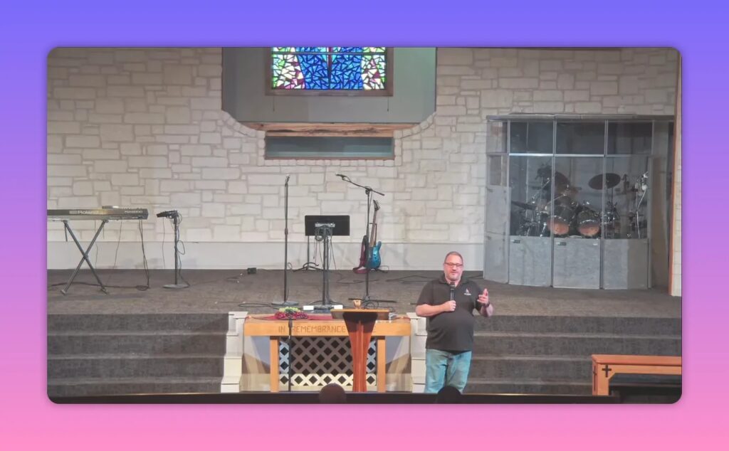Church speaker gesturing while teaching at lectern in church sanctuary