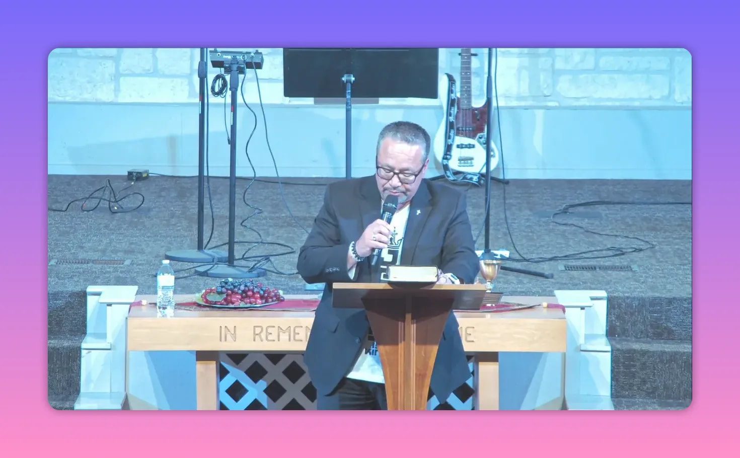 Preacher delivering a sermon at a church podium with microphone and open notes