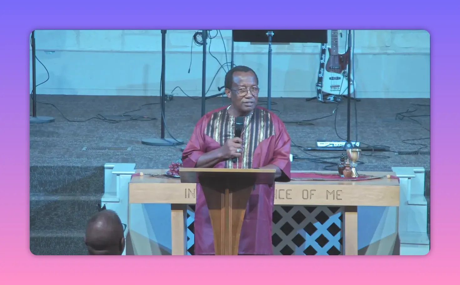 Pastor delivering a sermon at the front of a church sanctuary
