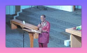 Pastor speaking from the pulpit on church steps during a sermon