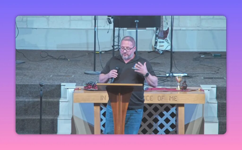 Pastor speaking with open hand gestures at a church podium