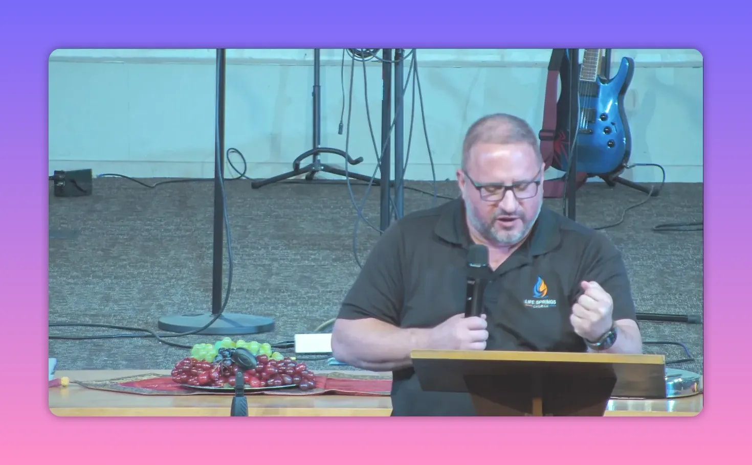 Speaker at lectern holding microphone while speaking during sermon