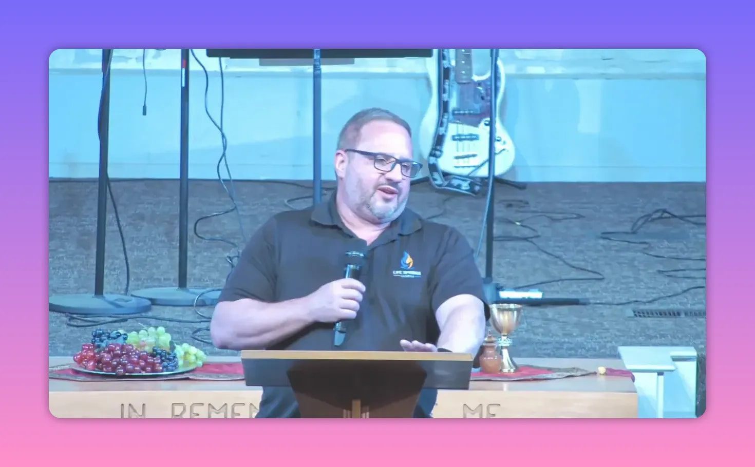 Speaker behind a podium holding a microphone during a church sermon